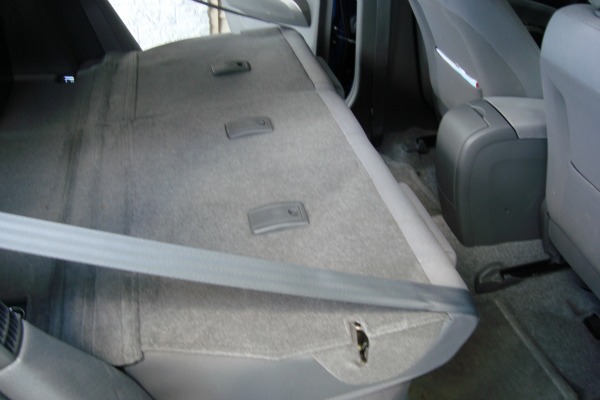 Rear passenger seats with headrests removed tilted all the way forward.